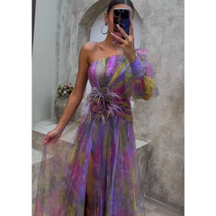 Helen colorful floral dress by THE WHITMORE FAMILY, elegant purple Bloemenjurk with intricate patterns and flowing fabric.