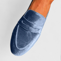 Blue Olivrah comfortable loafers by THE WHITMORE FAMILY, shown in a close-up view highlighting their stylish design and soft material.