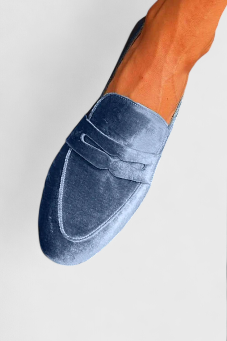 Blue Olivrah comfortable loafers by THE WHITMORE FAMILY, shown in a close-up view highlighting their stylish design and soft material.