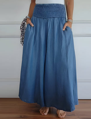 Blue Lorraine™ comfortable pants with elastic waist from THE WHITMORE FAMILY, featuring a relaxed fit and soft fabric.