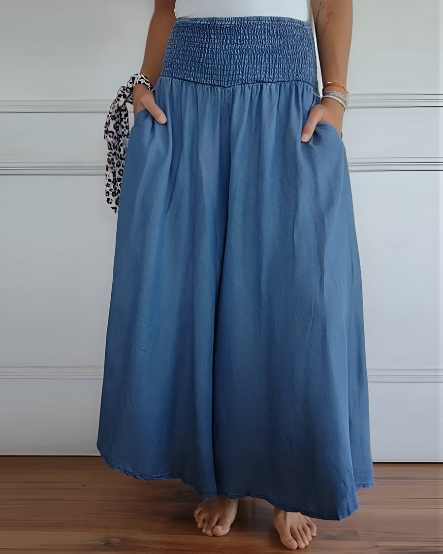 Blue Lorraine™ comfortable pants with elastic waist from THE WHITMORE FAMILY, featuring a relaxed fit and soft fabric.