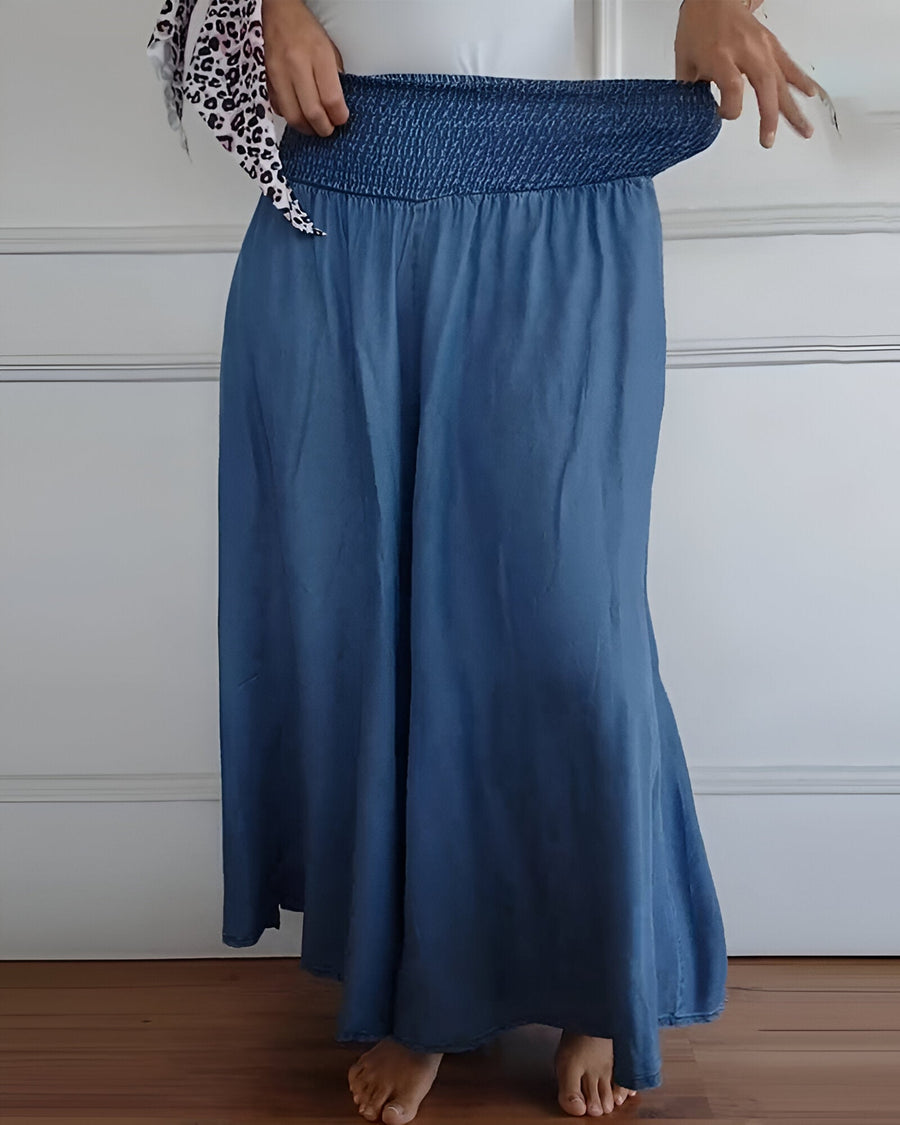 Blue Lorraine™ comfortable pants with elastic waist from THE WHITMORE FAMILY, featuring a relaxed fit and soft fabric.