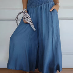 Blue Lorraine™ comfortable pants with elastic waist from THE WHITMORE FAMILY, featuring a relaxed fit and soft fabric.
