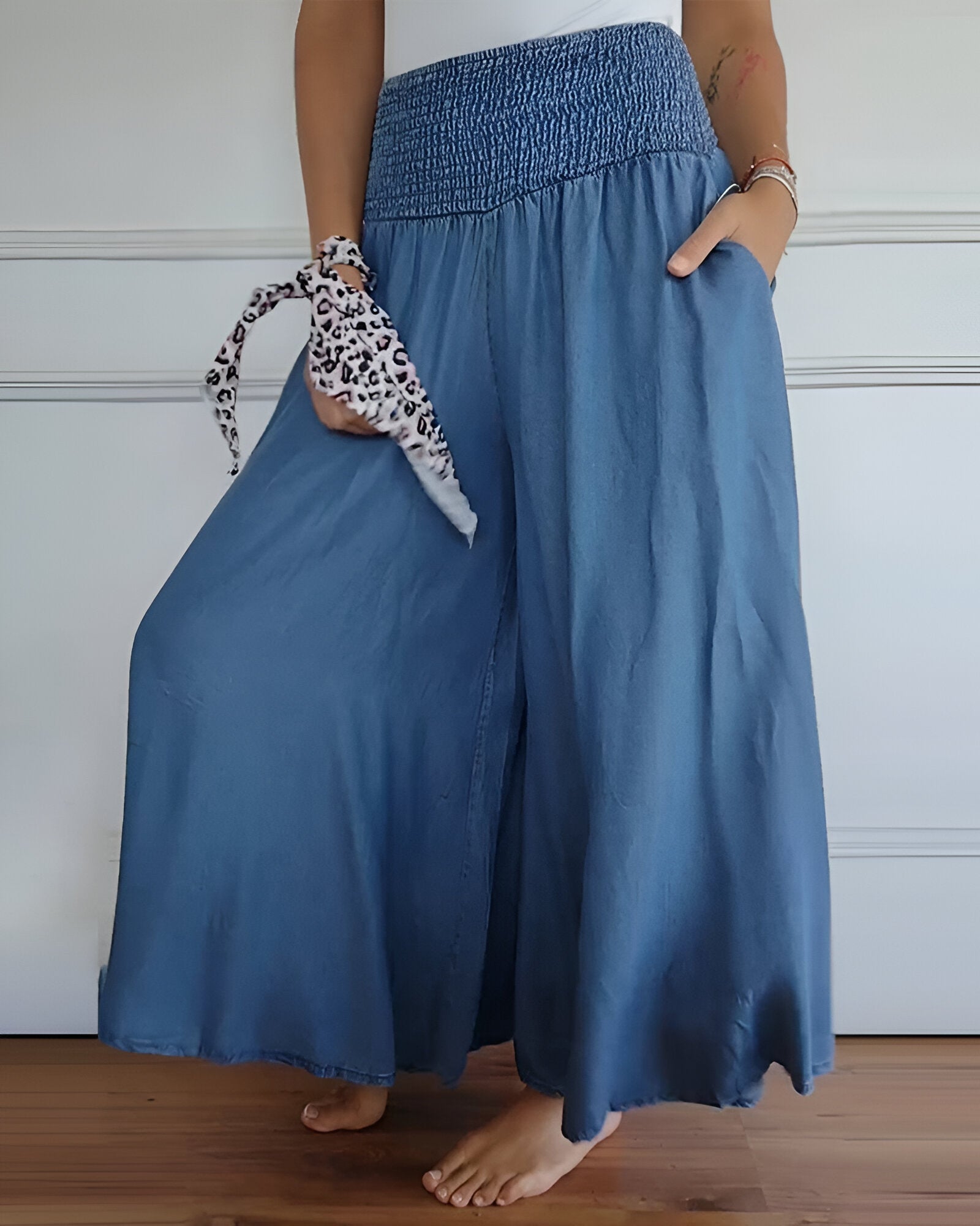 Blue Lorraine™ comfortable pants with elastic waist from THE WHITMORE FAMILY, featuring a relaxed fit and soft fabric.