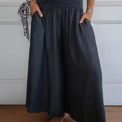 Blue Lorraine™ comfortable pants with elastic waist from THE WHITMORE FAMILY, shown on a model.