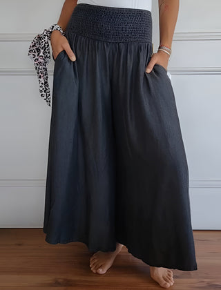 Blue Lorraine™ comfortable pants with elastic waist from THE WHITMORE FAMILY, shown on a model.