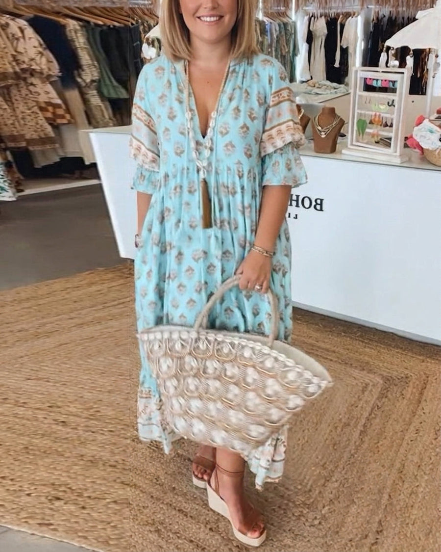 Bohemian Halcyon dress by THE WHITMORE FAMILY featuring flowing fabric and intricate patterns in earthy tones.