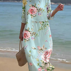 Sunset Flower Dress by THE WHITMORE FAMILY featuring blue floral pattern, lightweight fabric, and feminine design.