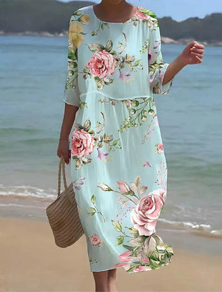 Sunset Flower Dress by THE WHITMORE FAMILY featuring blue floral pattern, lightweight fabric, and feminine design.