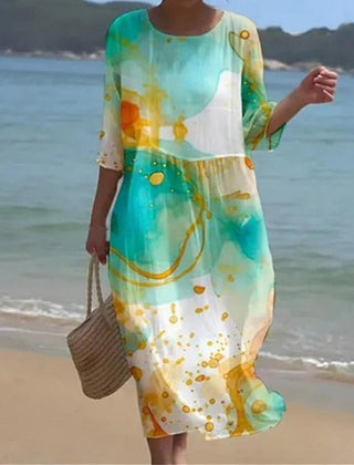 Sunset Flower Dress by THE WHITMORE FAMILY featuring blue floral pattern, flowing fabric, and sleeveless design.
