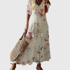 Blue boho vintage maxi dress by THE WHITMORE FAMILY, featuring flowing fabric and summer style, worn by a model outdoors.