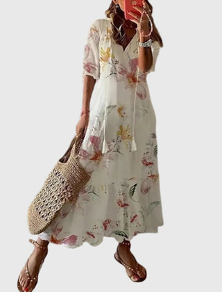 Blue boho vintage maxi dress by THE WHITMORE FAMILY, featuring flowing fabric and summer style, worn by a model outdoors.