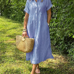 Blue Angela maxi dress by THE WHITMORE FAMILY, flowing fabric and elegant design, showcased on a model.