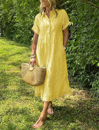 Blue Angela maxi dress by THE WHITMORE FAMILY featuring flowing fabric and a relaxed fit on a model.