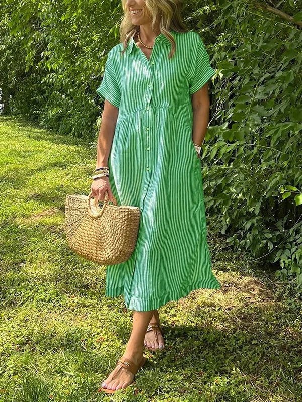 Blue Angela maxi dress by THE WHITMORE FAMILY, flowing fabric and elegant design, displayed on a hanger.