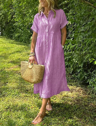 Blue Angela maxi dress by THE WHITMORE FAMILY, flowing fabric, sleeveless design, and elegant style displayed in the image.