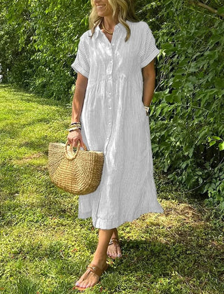 Blue Angela maxi dress by THE WHITMORE FAMILY, flowing fabric and elegant design displayed on a model.