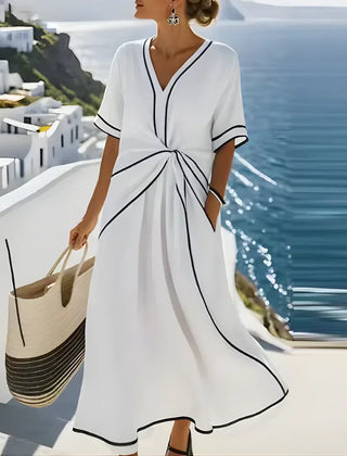 Blue Athena™ elegant flattering dress by THE WHITMORE FAMILY displayed on a mannequin, showcasing a stylish, flowing design.