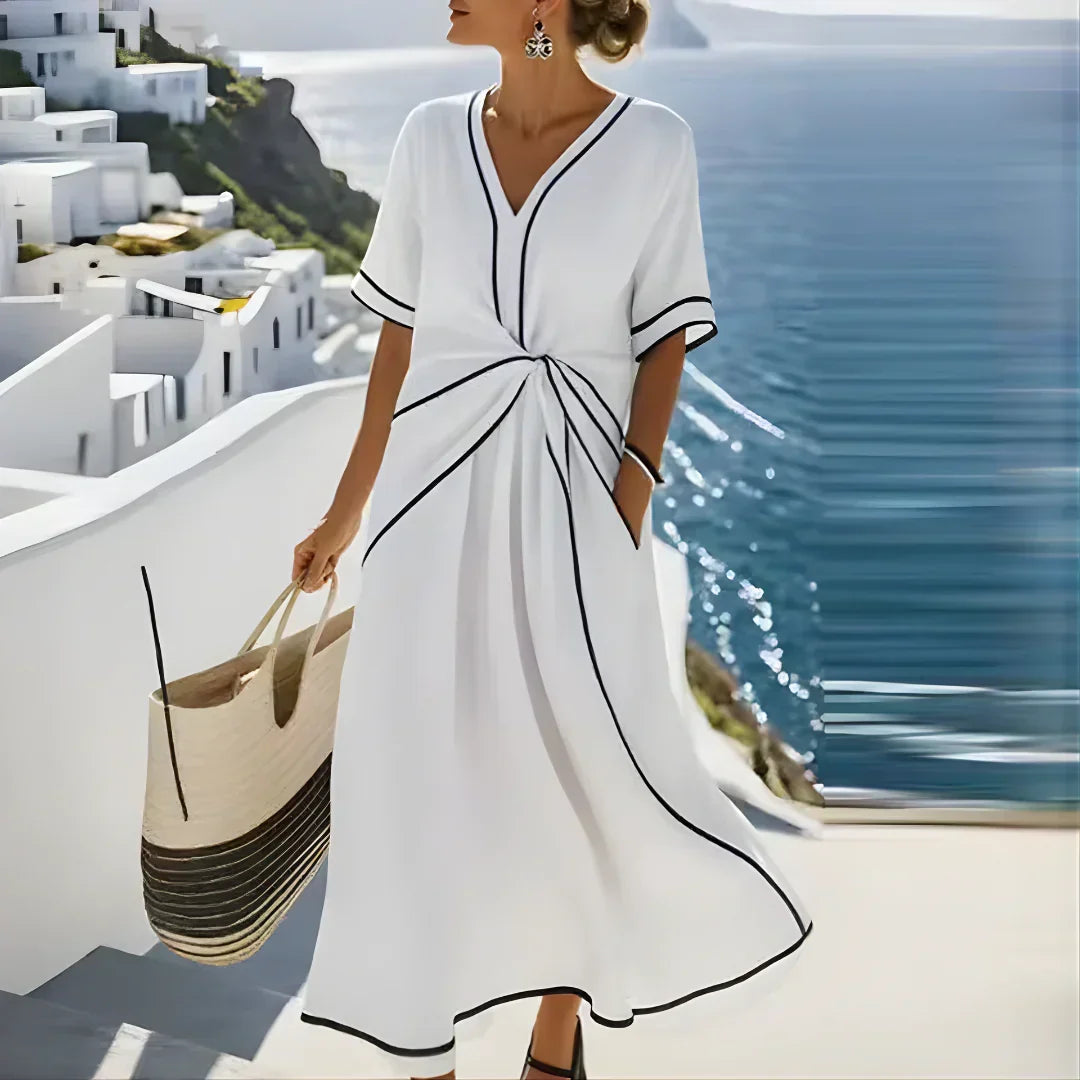 Blue Athena™ elegant flattering dress by THE WHITMORE FAMILY displayed on a mannequin, showcasing a stylish, flowing design.