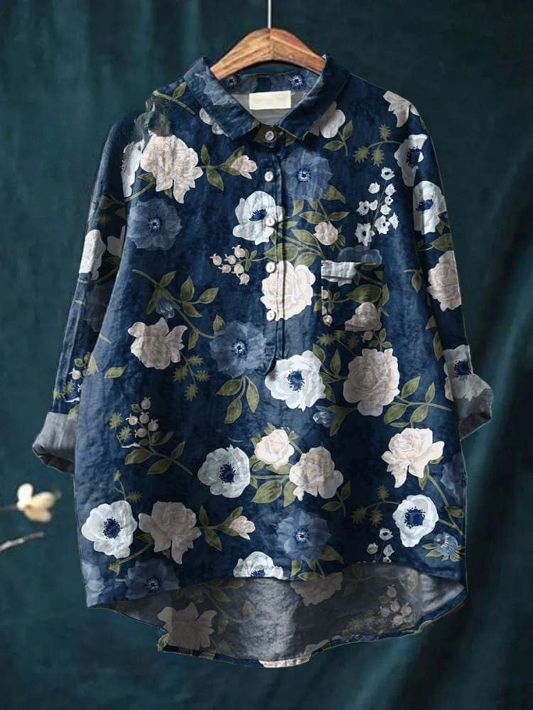Elegant floral shirt from THE WHITMORE FAMILY featuring a blue fabric and intricate floral pattern.
