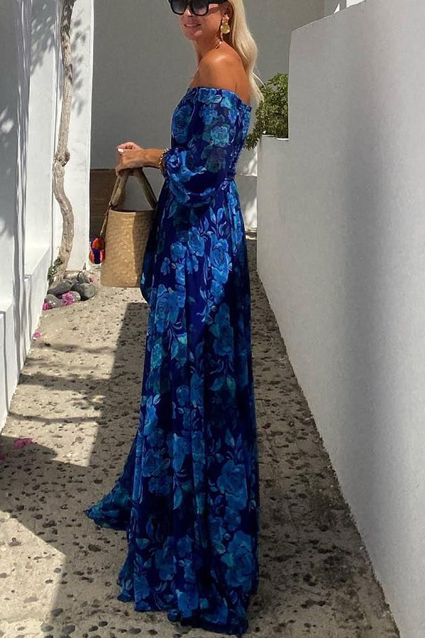 Blue Francesca long floral print dress by THE WHITMORE FAMILY, flowing fabric with vibrant flower patterns.