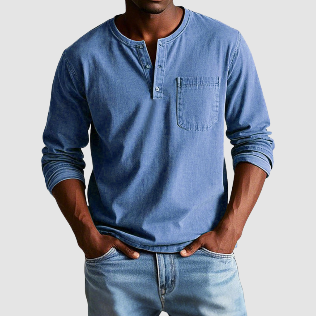 Blue Harrison™ Vintage Henley Shirt by THE WHITMORE FAMILY displayed on a hanger, showcasing its classic button-up style and fabric texture.