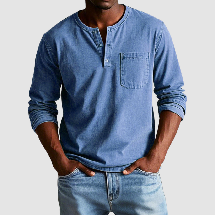 Blue Harrison™ Vintage Henley Shirt by THE WHITMORE FAMILY displayed on a hanger, showcasing its classic button-up style and fabric texture.
