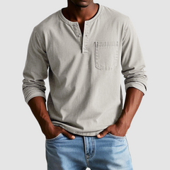 Blue Harrison™ Vintage Henley Shirt by THE WHITMORE FAMILY displayed on a hanger showing the button-front design and soft fabric.
