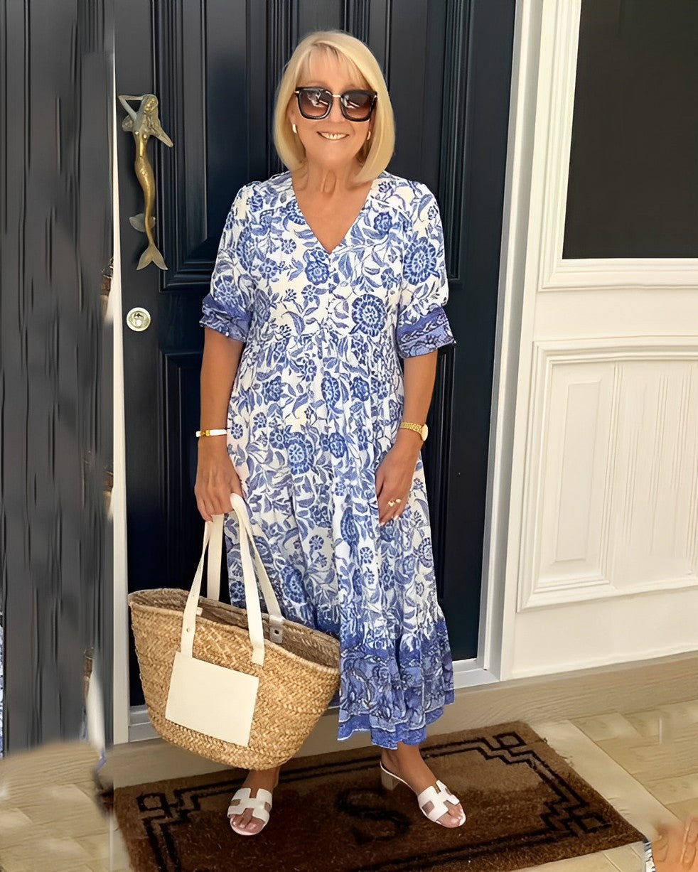 Blue Keisha floral V-neck top by THE WHITMORE FAMILY, featuring a graceful design with vibrant floral patterns.