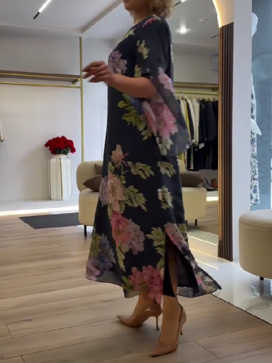Blue Nancy floral loose maxi dress by THE WHITMORE FAMILY featuring a flowy silhouette and vibrant floral pattern.