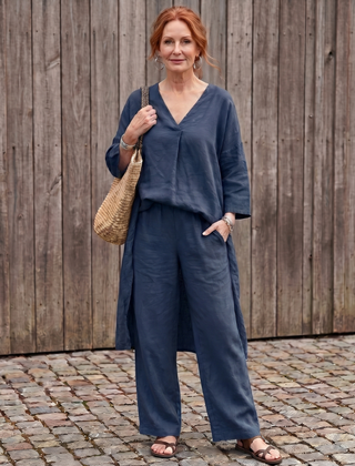 Blue loose tunic top and wide-leg pant set by THE WHITMORE FAMILY, styled for a relaxed, elegant look.