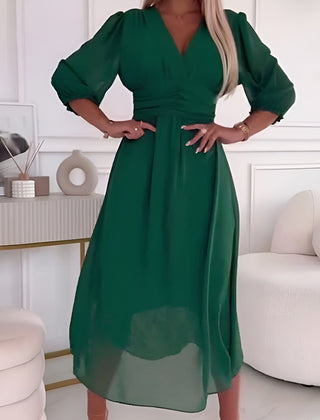 Blue Sophie elegant wrap dress by THE WHITMORE FAMILY, featuring a flattering silhouette and stylish design.