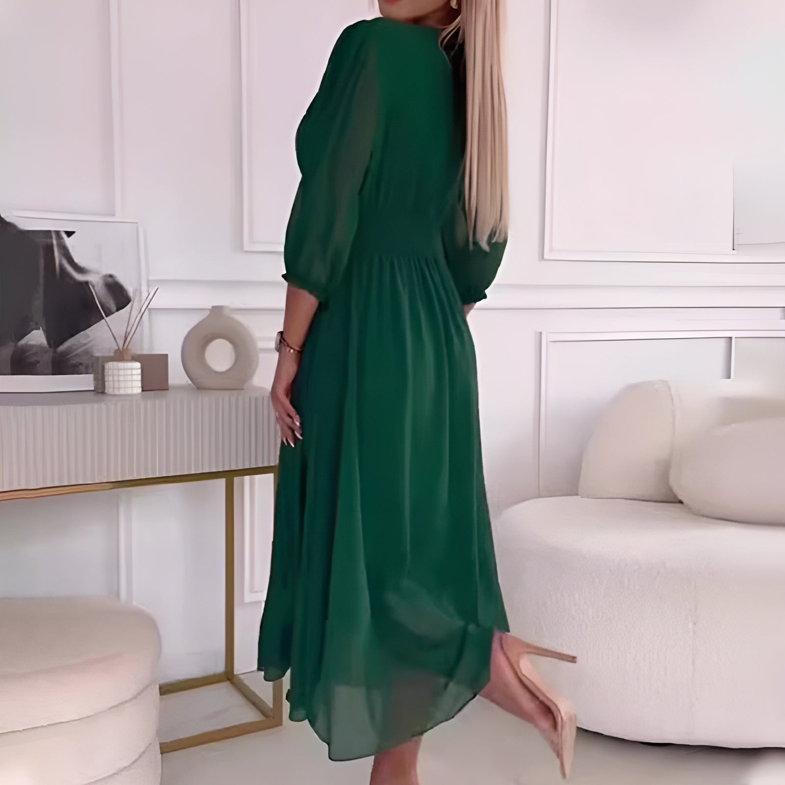 Blue Sophie elegant wrap dress by THE WHITMORE FAMILY, displayed on a mannequin with flowing fabric and a V-neckline.