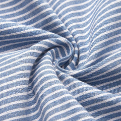 Blue Sofia™ striped summer dress by THE WHITMORE FAMILY, shown on a model with a fitted bodice and flowing skirt.
