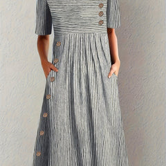 Blue Sofia™ striped summer dress by THE WHITMORE FAMILY, featuring a casual fit and vibrant pattern for warm weather wear.