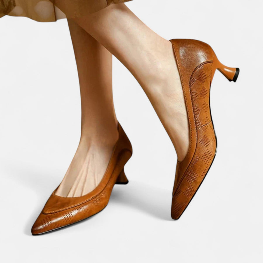Brown leather heels from THE WHITMORE FAMILY's Amara collection, featuring elegant pointed toes and sleek design.