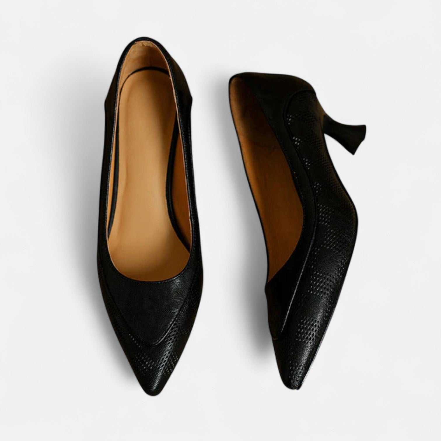 Brown leather heels from THE WHITMORE FAMILY's Amara collection, featuring a stylish, pointed toe design.