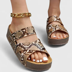 Brown Danyzelle™ orthopedic sandals by THE WHITMORE FAMILY, featuring supportive straps and cushioned soles for comfort.