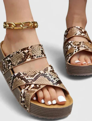 Brown Danyzelle™ orthopedic sandals by THE WHITMORE FAMILY, featuring supportive straps and cushioned soles for comfort.