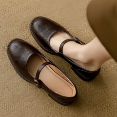 Brown Grace Classic Comfort Mary Janes by THE WHITMORE FAMILY, featuring a polished leather finish and a secure strap for casual wear.
