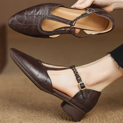 Brown leather Lily Mary Janes by THE WHITMORE FAMILY, featuring classic design and comfortable straps for young children.