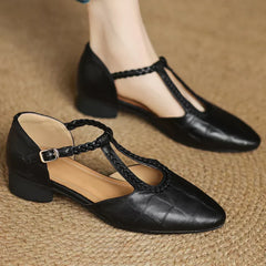 Brown leather Lily Mary Janes by THE WHITMORE FAMILY with rounded toes and decorative stitching, perfect for children.