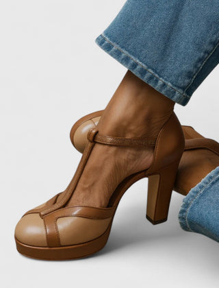 Brown Seliora sophisticated heels by THE WHITMORE FAMILY, featuring elegant design and pointed toe on a neutral background.