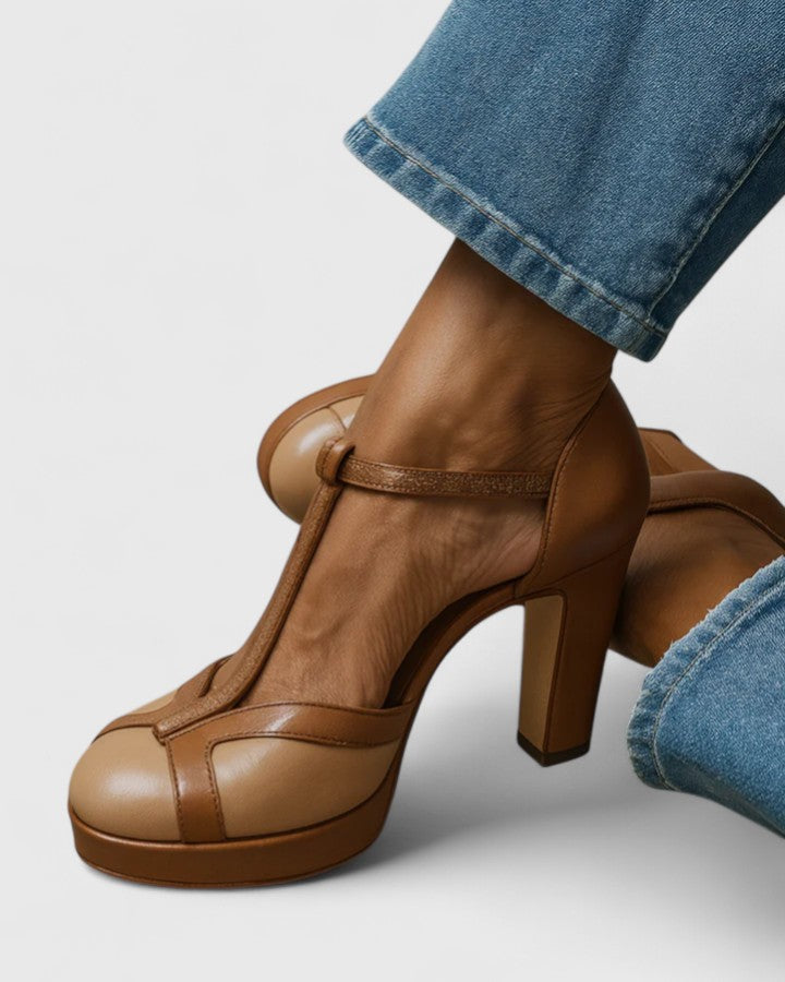 Brown Seliora sophisticated heels by THE WHITMORE FAMILY, featuring elegant design and pointed toe on a neutral background.