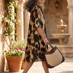 Brown Delara Wild Path Dress by THE WHITMORE FAMILY, featuring a flowing fabric and intricate pattern on a model.