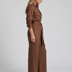 Brown Jovie long sleeve button-front wide-leg jumpsuit by THE WHITMORE FAMILY, featuring a relaxed fit and stylish design.