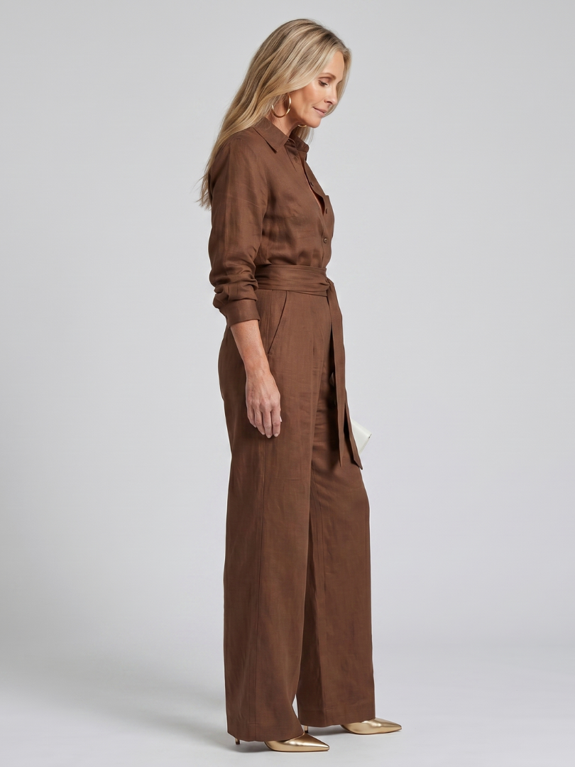 Brown Jovie long sleeve button-front wide-leg jumpsuit by THE WHITMORE FAMILY, featuring a relaxed fit and stylish design.