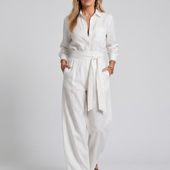 Brown Jovie long sleeve button-front wide-leg jumpsuit by THE WHITMORE FAMILY, featuring a stylish and comfortable fit.