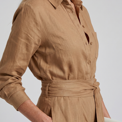 Brown Jovie long sleeve button-front wide-leg jumpsuit by THE WHITMORE FAMILY, styled with a relaxed fit and elegant design.