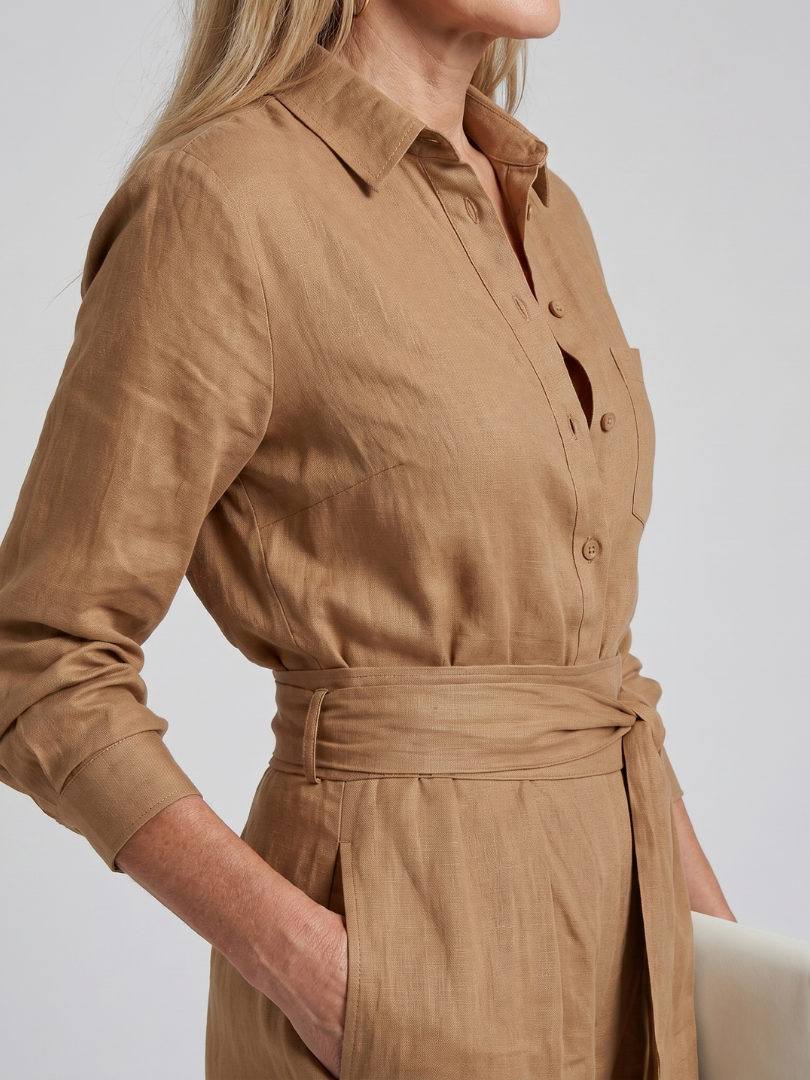 Brown Jovie long sleeve button-front wide-leg jumpsuit by THE WHITMORE FAMILY, styled with a relaxed fit and elegant design.